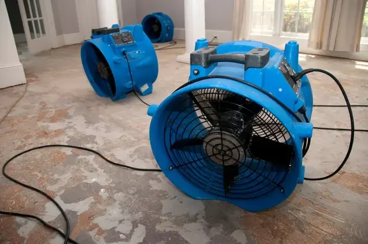 Air movers drying a stripped floor during an Aurora dry-out