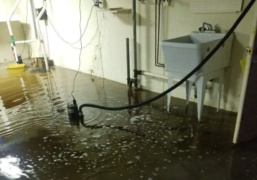 Sump pit and pump in an Aurora basement after water backed up